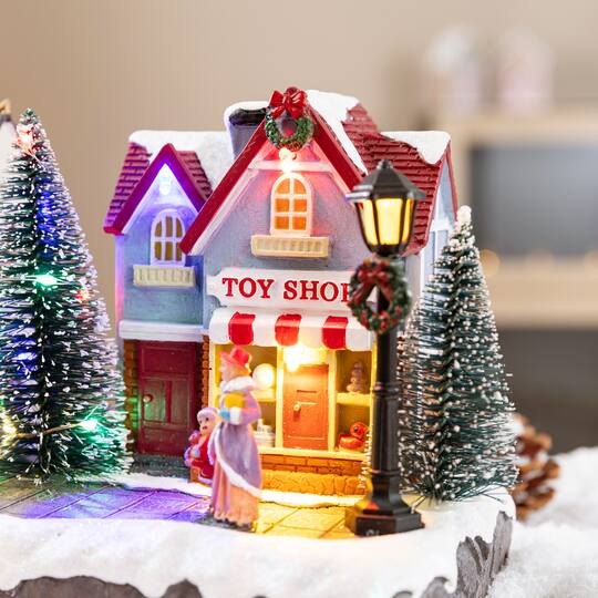 Glitzhome® 15.75" Lighted Christmas Resin Shop Avenue Musical Village with Timer